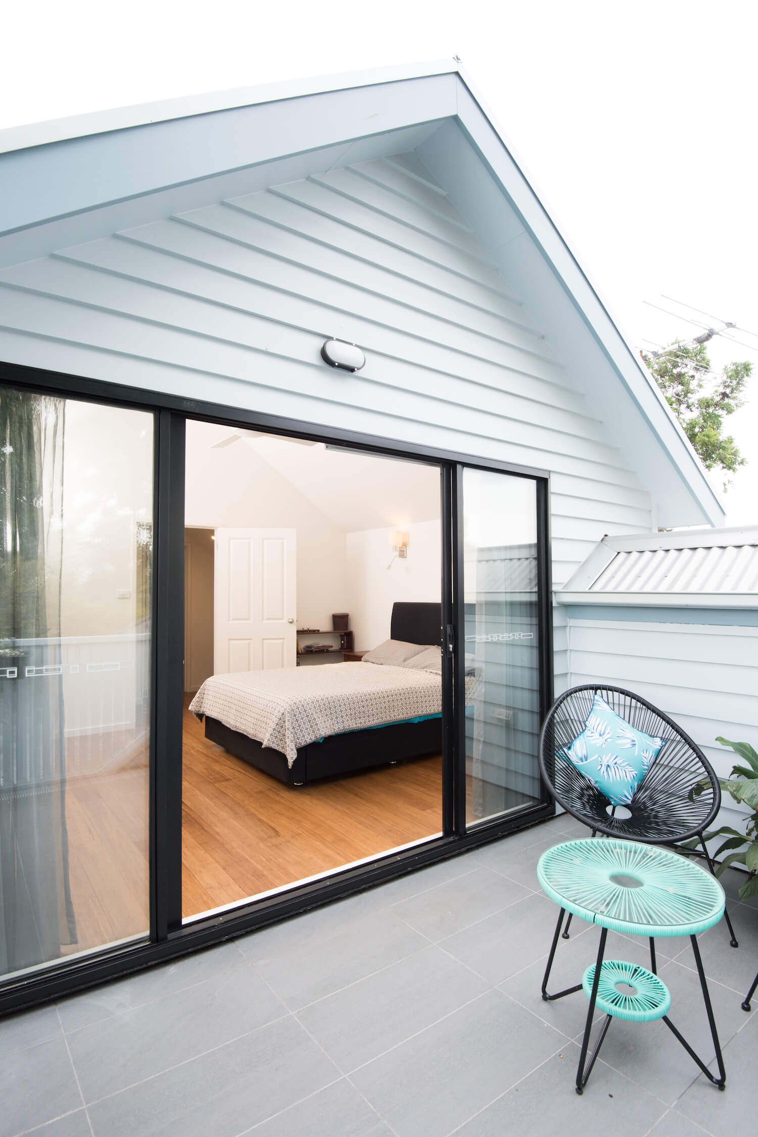 Photo of a bedroom flowing out to a balcony which formed part of an attic conversion