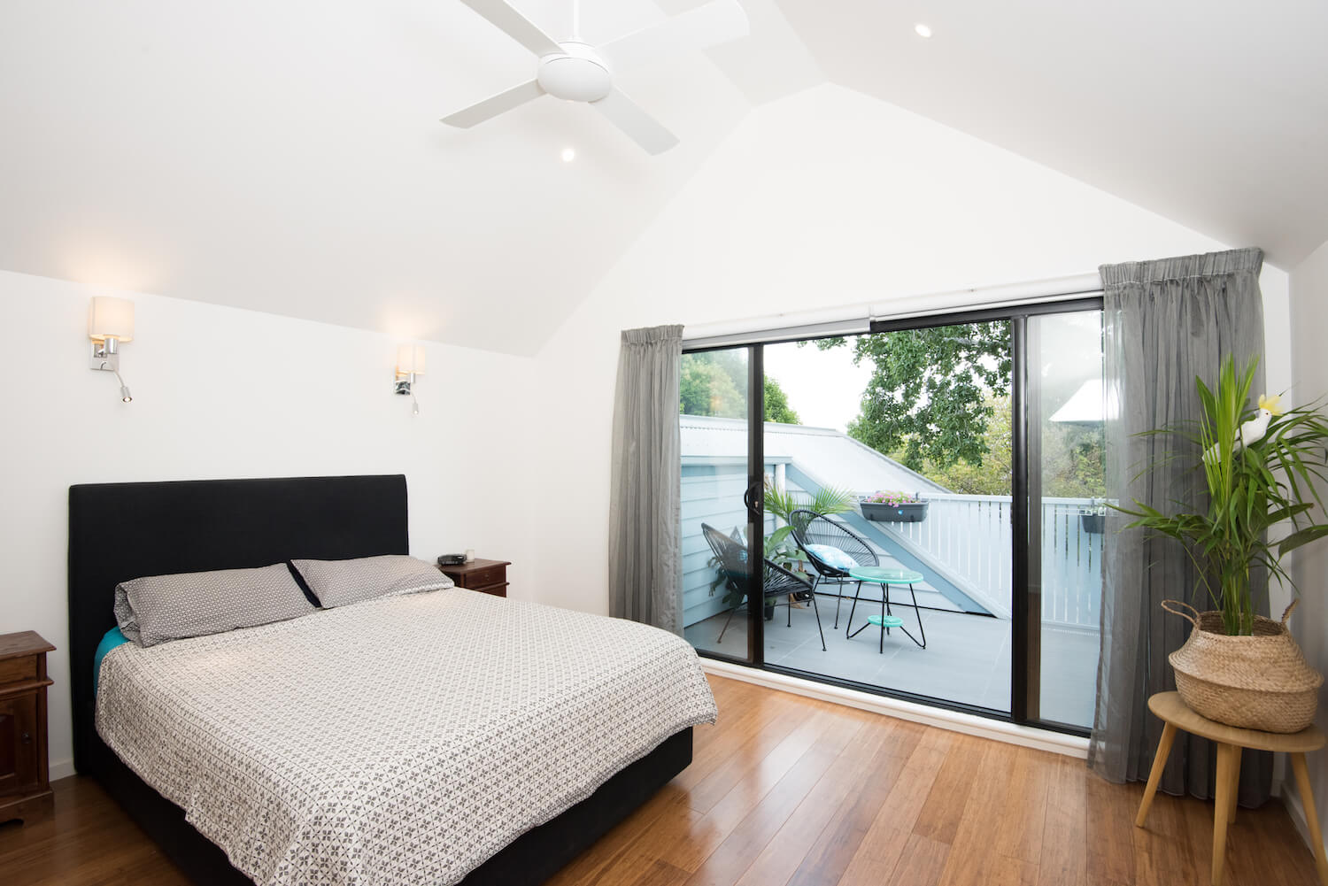Photo of a bedroom flowing out to a balcony which formed part of an attic conversion